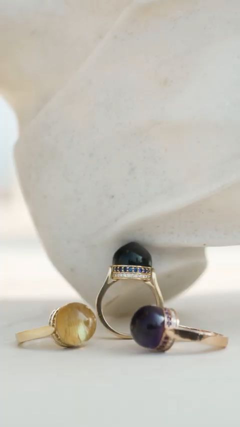 Three gemstone rings on white marble, from the Damas x Dome vertical film