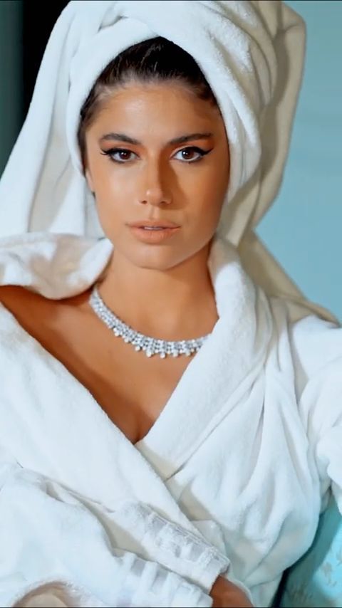 Model in a white robe and towel with a diamond necklace, from the vertical L'Officiel Baltic edit