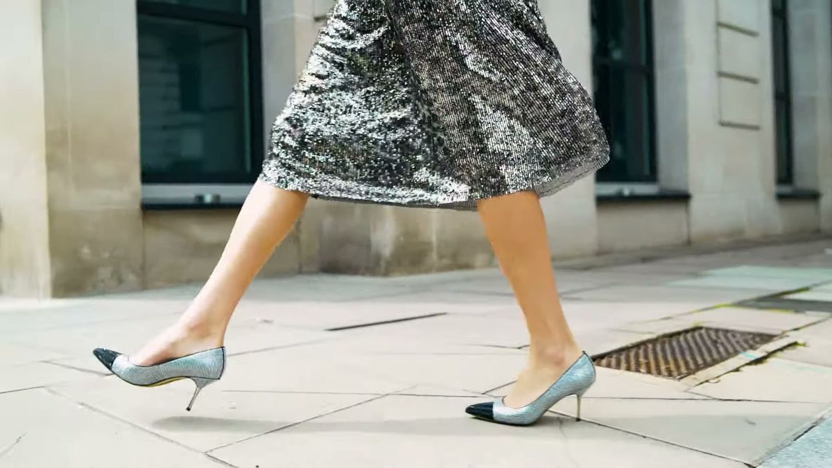 Sequin skirt and two-tone heels walking along a London pavement