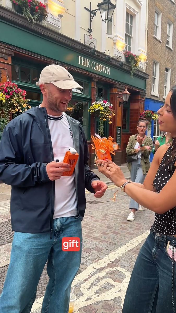 Street interview in central London, a passer-by holding the product while answering