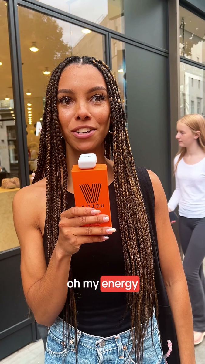Street interview on a London pavement, a woman reacting to the product