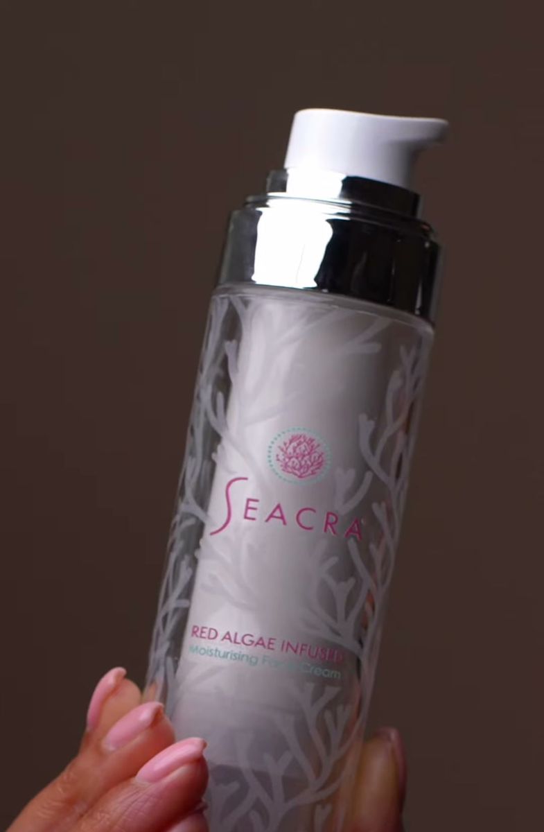 Seacra Red Algae Infused bottle held against a dark studio backdrop