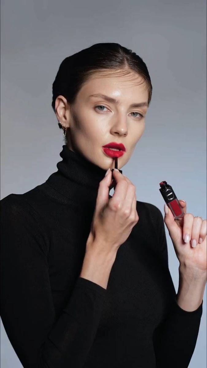 Model applying a red lip with the bottle held beside her face, Waterproof beauty film