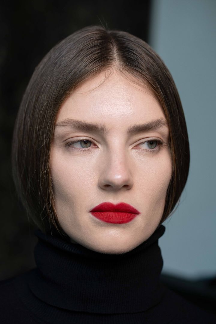 Model Vika with a crimson red lip and black high neck, beauty photoshoot in Dubai